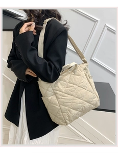 Close-up of beige quilted tote bag with rhombus stitching and comfortable shoulder strap