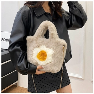Detail of plush crossbody bag featuring fried egg applique and gold metal chain strap