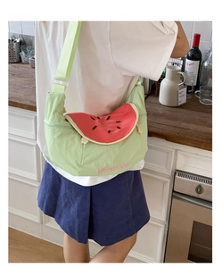 Close-up of cute light green watermelon crossbody bag with pink Watermelon embroidery detail