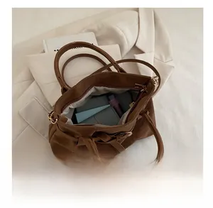 Macro top view of brown faux suede tote bag showing large capacity for daily items