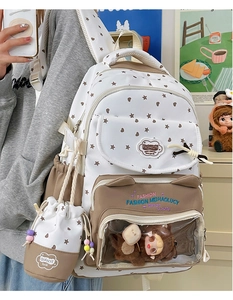 Close-up of student backpack featuring star heart patterns and transparent plush toy window