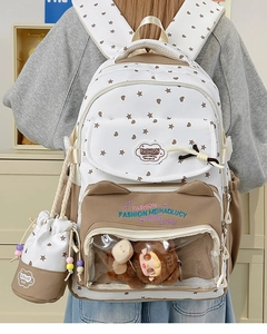Detail of school backpack with transparent window pocket and plush bear charm