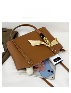 Detailed top view of brown tote bag showing capacity for phone, tablet and umbrella