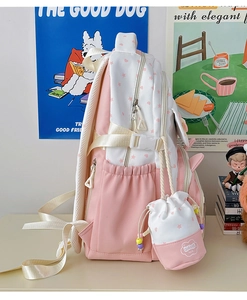 Detailed view of pink and white school backpack with matching star print mini pouch charm