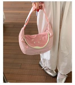 Close-up of pink watermelon slice crossbody bag with wide strap and zipper detail