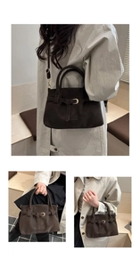 Detail view of dark brown suede tote bag with golden buckle and adjustable shoulder strap