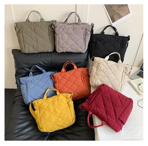 Detail view of quilted tote bags in eight colors featuring nylon fabric and grid patterns