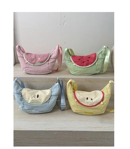 Detail of four colorful fruit-themed crossbody bags in pink, green, blue, and yellow