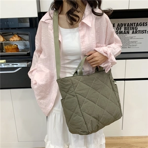 Army green large quilted tote bag with adjustable shoulder strap and side pockets