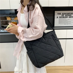 Quilted black canvas tote bag for women with large capacity and diamond stitch detail