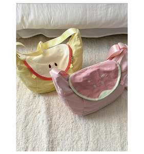 Detail showing cute macaron fruit crossbody bags in pink watermelon and yellow apple style