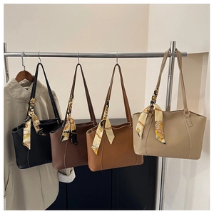 Detail of four matte PU leather tote bags in black, brown, and beige with silk scarf accents
