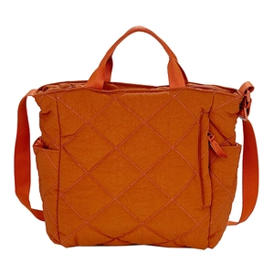 Quilted orange tote bag with diamond pattern, double handles and adjustable strap