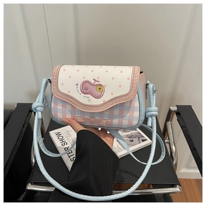 Detail of sweet plaid crossbody bag with pink polka dot flap and bow decoration