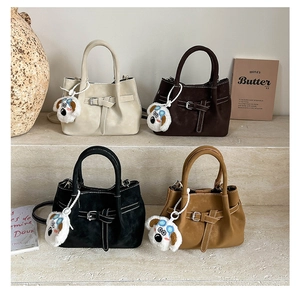 Minimalist matte bucket bags in four colors with contrast stitching and plush dog charms