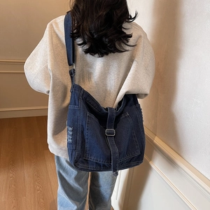 Vintage washed blue denim tote bag with adjustable shoulder strap for casual daily use