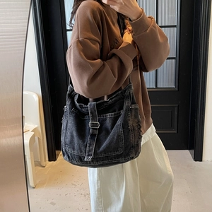 Retro washed black denim hobo bag featuring a large capacity and adjustable strap