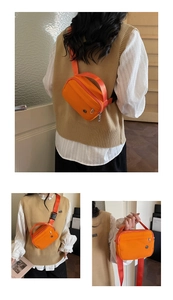 Detail shots showing the versatile ways to wear the orange nylon crossbody bag with wide strap