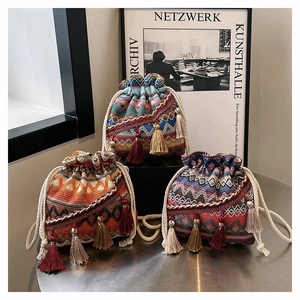 Detailaufnahme von Boho-Stickerei-Beuteltaschen mit Quasten und gewebten Kordelzügen