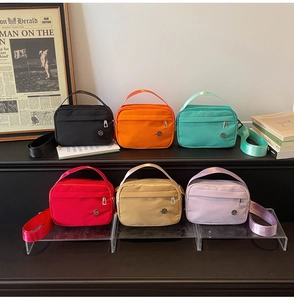 Detailed view of colorful nylon crossbody bags in a stylish lifestyle display setup