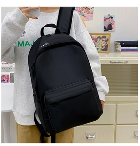 Side view of black canvas backpack showing large capacity pocket and side water bottle holder