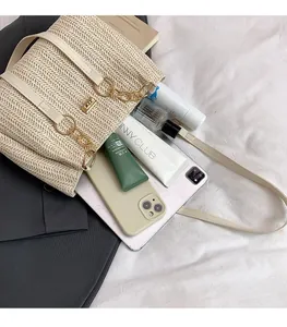 Detail view of woven shoulder bag showing large interior space for phone and makeup