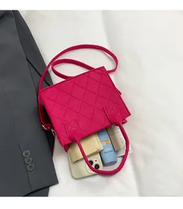 Detail view of pink quilted felt handbag interior showing spacious storage for daily items