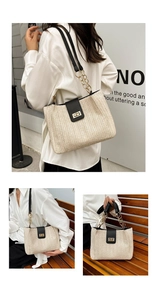 Detailed close-up of woven straw tote bag with black leather flap and gold turn-lock closure