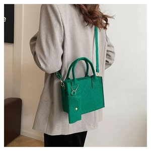Detailed view of green quilted felt tote bag with matching mini pouch and shoulder strap