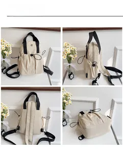 Detail view of cream nylon backpack showing drawstring pocket and adjustable straps