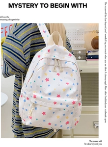 Detail of star print backpack with vibrant colorful patterns and side storage pocket