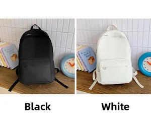 Detailed comparison of minimalist canvas backpacks in classic black and white color options