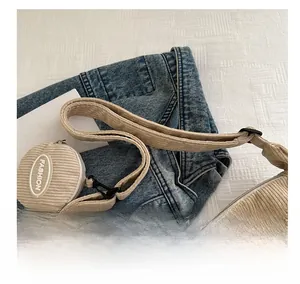 Detail view of beige corduroy shoulder bag with small fashion coin pouch attachment