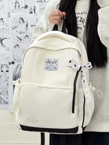 Detail of cream canvas backpack with Frankie patch and polka dot ribbon on comic background