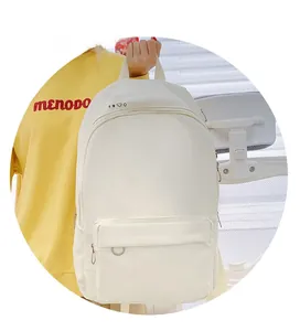Close-up of white water-resistant nylon backpack with zipper pocket and metal D-ring detail