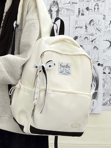 Close-up of a white backpack with a black base, featuring a bow and logo label details