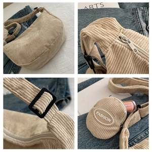Detail of beige corduroy crescent bag showing zipper and fashion round coin purse