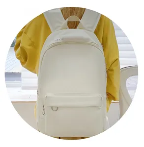 Detailed view of a white minimalist backpack featuring small sun and heart embroidered icons