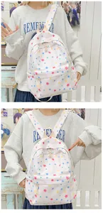 Detail of star print backpack with front pocket and cream handles in a retro setting