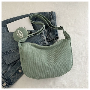 Detail of green corduroy tote bag with a matching round coin purse and striped texture