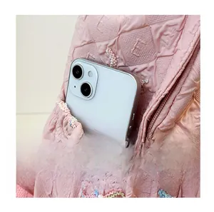 Detailed view of the side pocket on pink quilted backpack for school and travel use