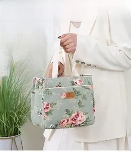 Detail of floral canvas bento tote with vintage rose print and secure zipper closure