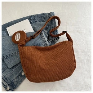 Detail of brown corduroy hobo bag with matching mini round coin purse and logo