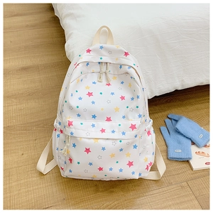 Close-up of colorful star pattern on white canvas backpack with woven zipper detail