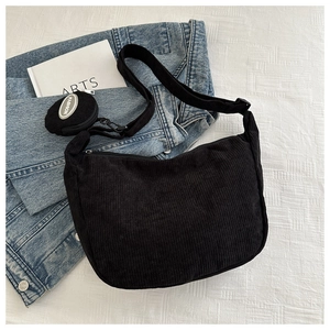 Detail of black corduroy hobo bag with matching mini coin purse and fashion tag