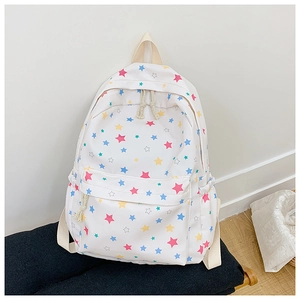 Detailed close-up of a white star-print canvas backpack with colorful pastel patterns