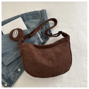 Detail of coffee brown corduroy crescent bag with adjustable strap and fashion coin purse