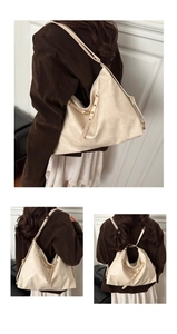 Detail of the soft cream leather shoulder bag with adjustable straps and versatile design