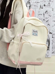 Detail of Korean JK style backpack with pink ribbons and heart prints on a female model