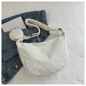 Detailed texture of white corduroy hobo bag featuring a matching mini round coin purse